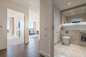 Et stilfuldt badeværelse med toilet, vask og spejl.
