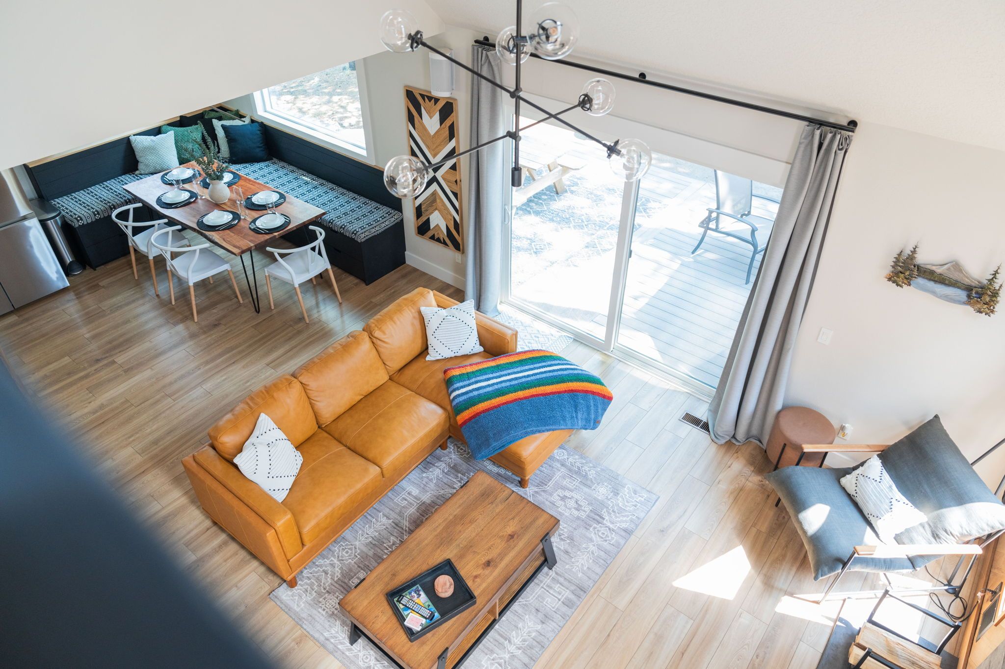 A spacious living area with a sofa, coffee table, and a dining table set for four.
