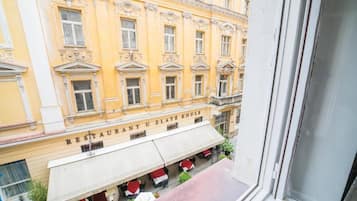 A building with a restaurant named 'RESTAURANT U ZLATÉ KOULE' with outdoor seating and a window view.