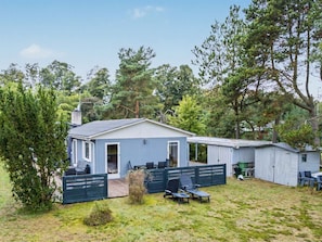 A single-story house with a covered patio area, a fenced yard, and a small shed. - "Karelia" - 900m from the sea by Interhome (Væggerløse)