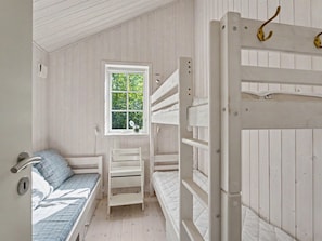 A room with bunk beds, a window, and a door with a handle. - "Heidrun" - 400m from the sea by Interhome (Væggerløse)