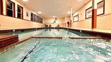 A swimming pool with multiple lanes, tiled walls, and a tiled floor.