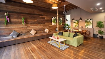 A modern interior with a wooden wall, seating area, and dining space.