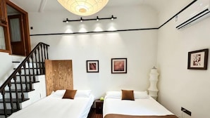 A hotel room with two beds, a wooden headboard, a staircase, and a ceiling light fixture. - Tonighy Homestay Jing'an Temple Shanghai (Shanghai)