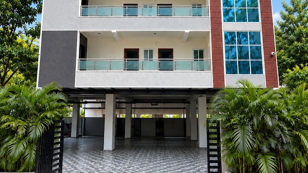A multi-story building with a flat roof, balconies, and a checkered tile entrance. - Orion Signature Hotel  (Hyderabad)
