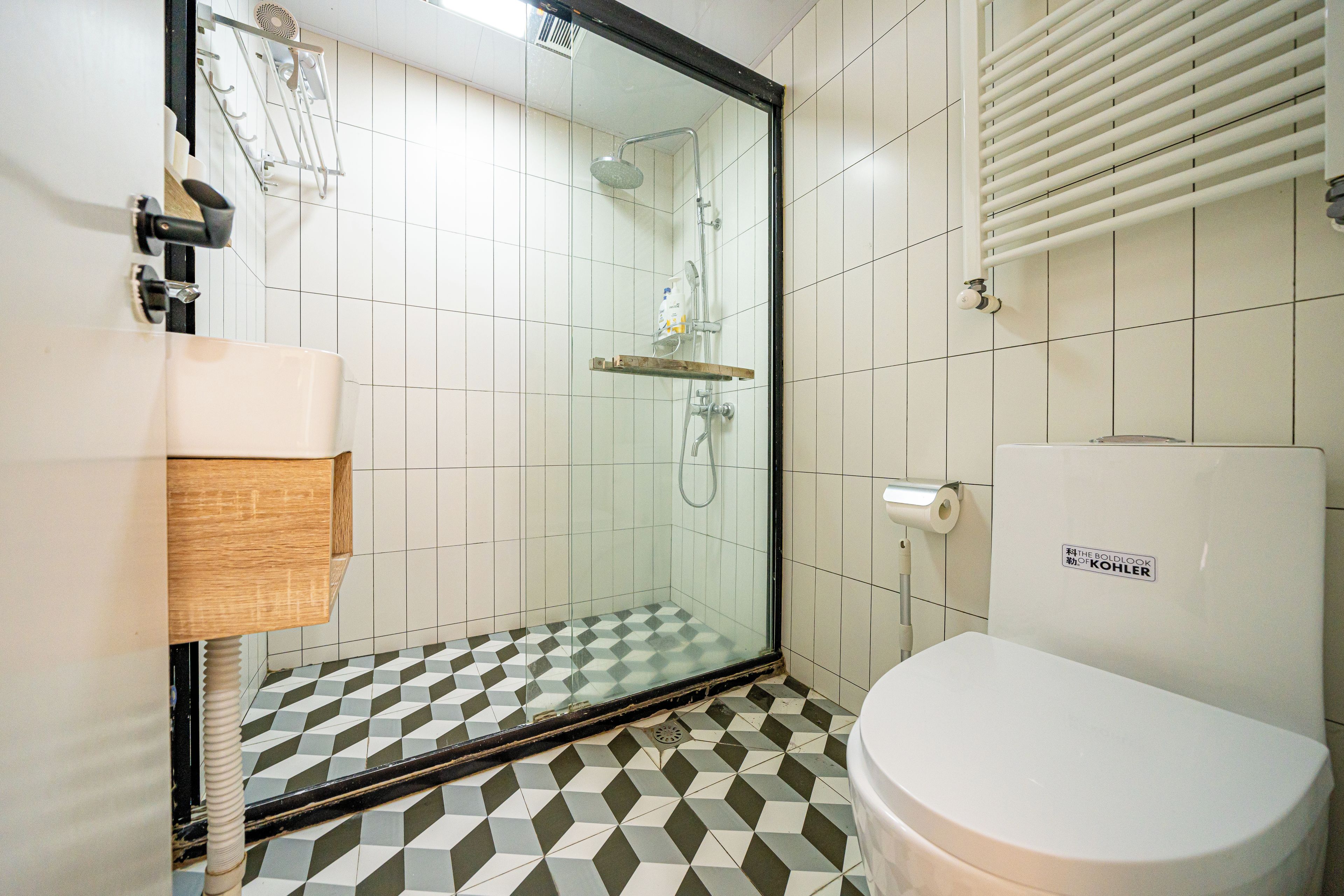A bathroom with a shower, toilet, and a sink.