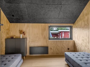 A room with a window, a sofa, a cabinet, and a flat-screen TV. - "Munibert" - 100m from the sea by Interhome (Sjølund)