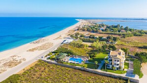 A coastal property with a swimming pool, beachfront access, and a large villa. - San Giovanni Luxury Studios (Lefkada)
