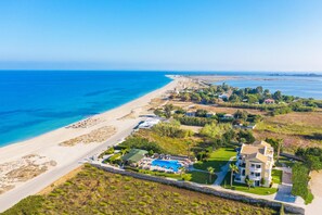 A coastal property with a swimming pool, beachfront access, and a large villa. - San Giovanni Luxury Studios (Lefkada)