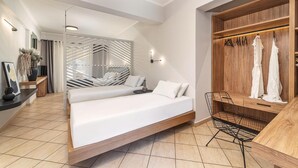 A modern bedroom with a bed, a seating area, and a wardrobe. - San Giovanni Luxury Studios (Lefkada)