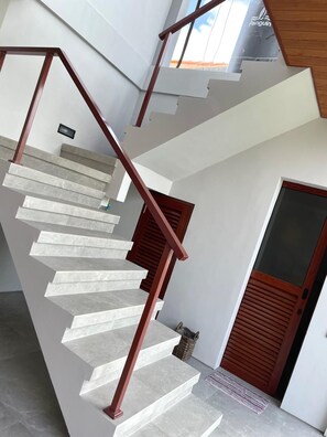 A spiral staircase with a modern design, leading to an upper floor. - Rumah Melissa Modern Boho 3BR Villa in Sanur (Denpasar selatan)