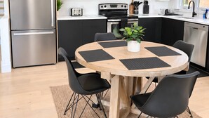 A modern kitchen with a built-in oven, microwave, and stainless steel refrigerator. - Modern 3BR Home Near Cheo & General Hospital (Ottawa)