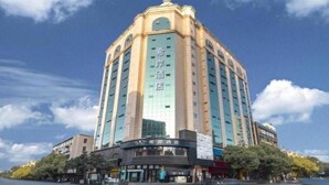 A multi-story hotel with a prominent entrance and signage indicating it is a hotel. - Xana Hotelle (Nanchang)