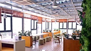 A modern interior with a reception desk, seating area, and large windows. - Lavande Hotel (Suzhou)