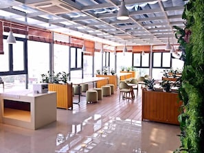A modern interior with a reception desk, seating area, and large windows. - Lavande Hotel (Suzhou)