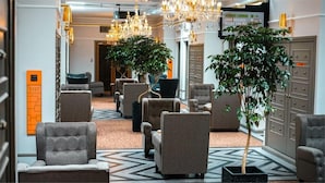 A hotel lobby with seating areas, a chandelier, and a sign indicating a garden lounge. - 1969 Business Suites @ Ipoh Garden (Ipoh)