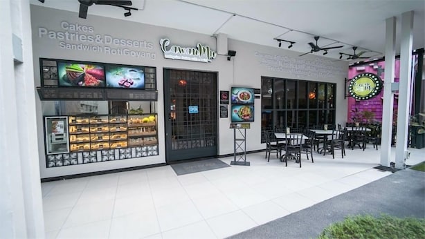 A storefront with a sign for 'Cawand Mie' featuring cakes, pastries, and desserts. - 1969 Business Suites @ Ipoh Garden (Ipoh)