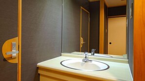 A bathroom with a sink, mirror, and a door. - Taoya Nasu Shiobara (Nasushiobara)