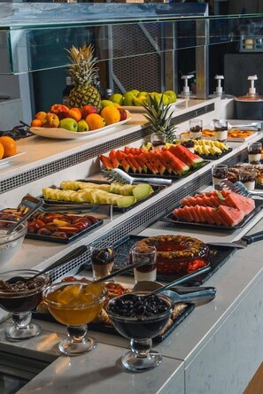 A buffet with various fruits, vegetables, and desserts. - Cretan Blue Beach Hotel (Hersonissos)