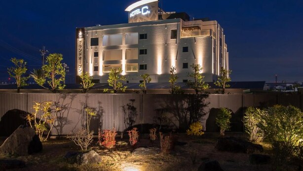 A hotel with a modern design, featuring multiple floors and a prominent sign. - Hotel C. Chiba Shiroi (Shiroi)