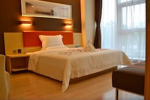 A hotel room with a bed, bedside tables, a nightstand, a window with curtains, and a wall-mounted light fixture. - 7 Days Premium Beijing Dujiakan Yuanbo (Beijing)