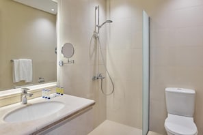 Ein modernes Badezimmer mit Waschbecken, Spiegel und Dusche.
