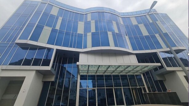 A modern building with a curved facade and large glass windows. - Nur Al Naseem by Makarem (Makkah)