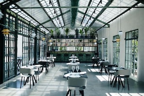 A spacious indoor dining area with tables and chairs arranged for guests. - Roncolo 1888 (Quattro Castella)