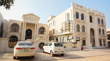 A large, multi-story building with classical architectural elements, including arched windows and a central entrance.