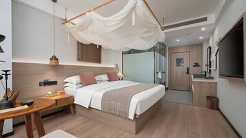 A modern hotel room with a bed, bedside table, and a TV.