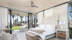 A modern bedroom with a large bed, bedside tables, a ceiling fan, and a view of the outdoors. - Susurros del Corazon, Auberge Resorts Collection (Punta de Mita)