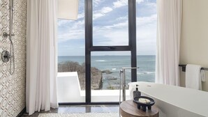 A bathroom with a bathtub, a shower, and a view of the ocean. - Susurros del Corazon, Auberge Resorts Collection (Punta de Mita)