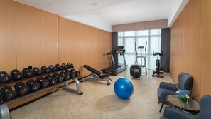 A gym with exercise equipment, a bench, dumbbells, and a blue exercise ball. - Holiday Inn Express Nanning Convention and Exhibition (Nanning)