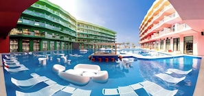 A hotel with a large indoor swimming pool, multiple balconies, and a modern architectural design.