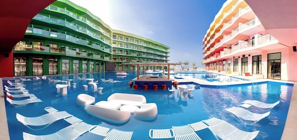 A hotel with a large indoor swimming pool, multiple balconies, and a modern architectural design.