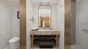 A modern bathroom with a marble vanity, a toilet, and a shower with a geometric tile pattern.