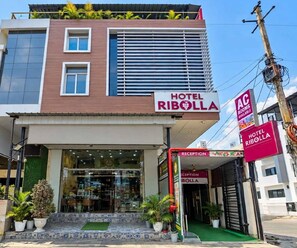 A hotel with a modern facade, a reception area, and a visible entrance. - Classical Ribola I (Indore)
