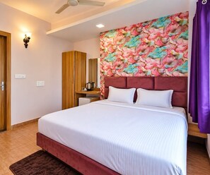 A hotel room with a bed, a wardrobe, a bathroom, and a shower area. - Classical Ribola I (Indore)