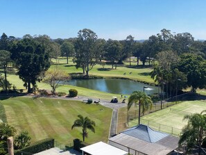 A golf course with a pond, surrounded by trees and a clear sky. - Gold Coast central, fabulous golf course resort, near beach, shops, restaurants (Clear Island Waters)