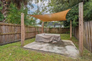 A backyard with a covered patio area, wooden fence, and a house in the background. - 2 Mi to Dtwn Savannah! WFH-Friendly Retreat (Savannah)