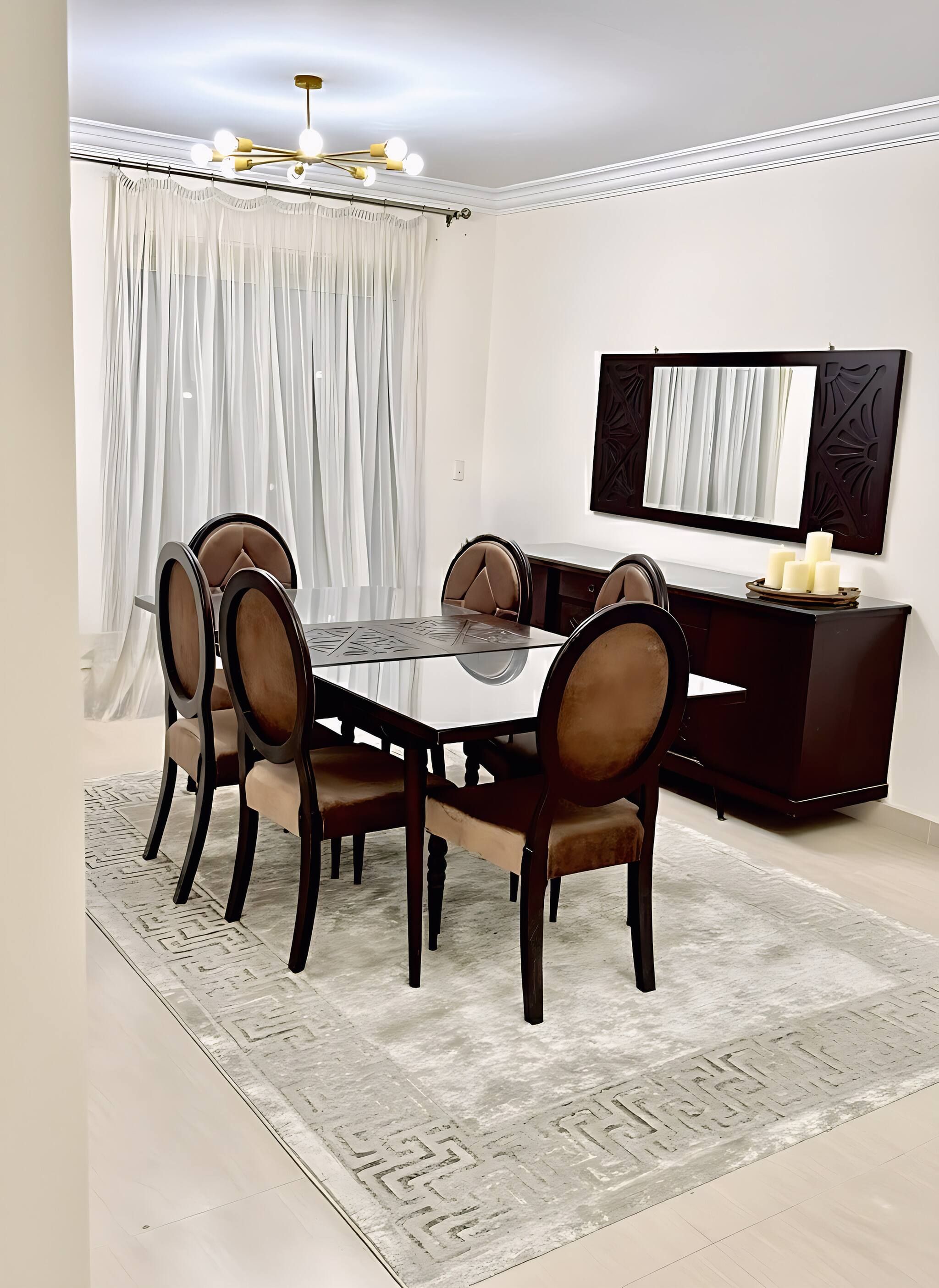 A dining area with a round table, six chairs, a dark wooden cabinet, and a chandelier.