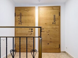 A room with two wooden doors labeled 'Edelweiss' and 'Enzian.' - Kombi Edelweiss+Enzian by Interhome (Mayrhofen)