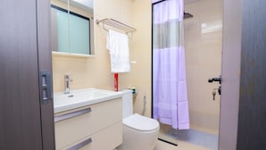 A bathroom with a toilet, sink, and shower area. - Spacious 1-bedroom apartment in Westlands, Nairobi, Kenya (Nairobi)