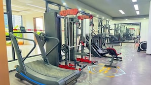 A gym with treadmills, weight machines, and a mirrored wall. - Spacious 1-bedroom apartment in Westlands, Nairobi, Kenya (Nairobi)