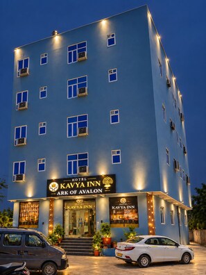 A multi-story hotel building with a sign reading 'Kavya Inn Ark of Avalon'. - HOTEL KAVYA INN  (New Delhi)