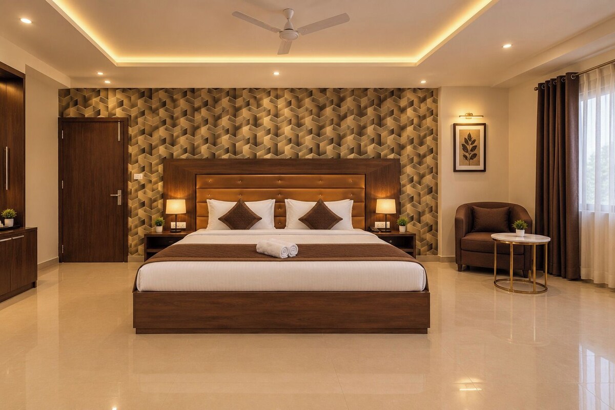 A modern hotel room with a large bed, a ceiling fan, a sofa, and a small table.