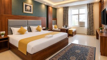 A hotel room with a large bed, bedside tables, a TV, and a window with curtains.