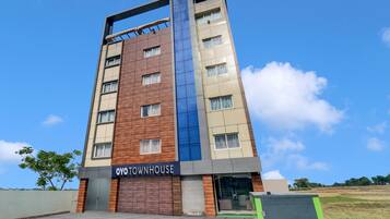 A multi-story building with a sign reading 'OYO TOWNHOUSE.'