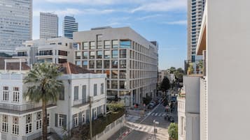 A multi-story building with a modern architectural design, featuring a mix of glass and concrete facades.