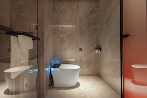 A modern bathroom with a glass shower enclosure, a white toilet, and a glass-enclosed bidet. - FURAMA SHANSHUI HOTEL (Jiangmen)